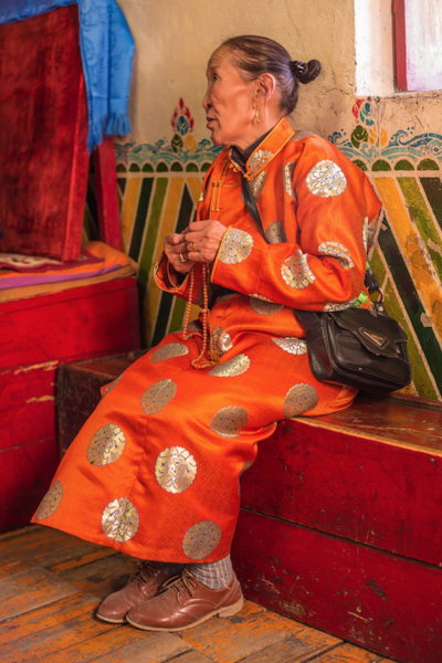Mongolian lady counting mantras on her mala.